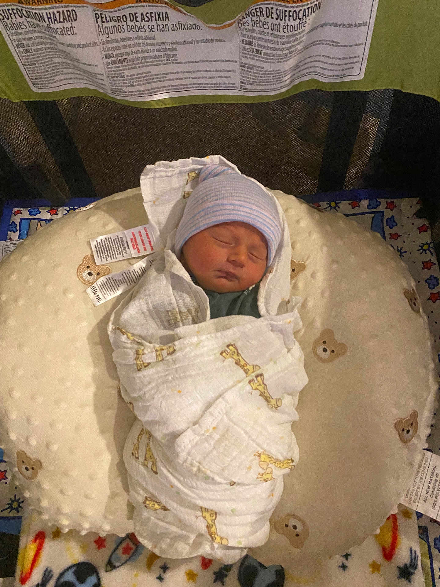 Braxton joined the competition — help win amazing prizes! newborn, baby, sleeping, swaddled, blanket, hat, pillow, bear_pattern, giraffe_pattern, crib, playpen, infant, resting, soft_texture, cozy, indoor, child, cute, peaceful, nursery