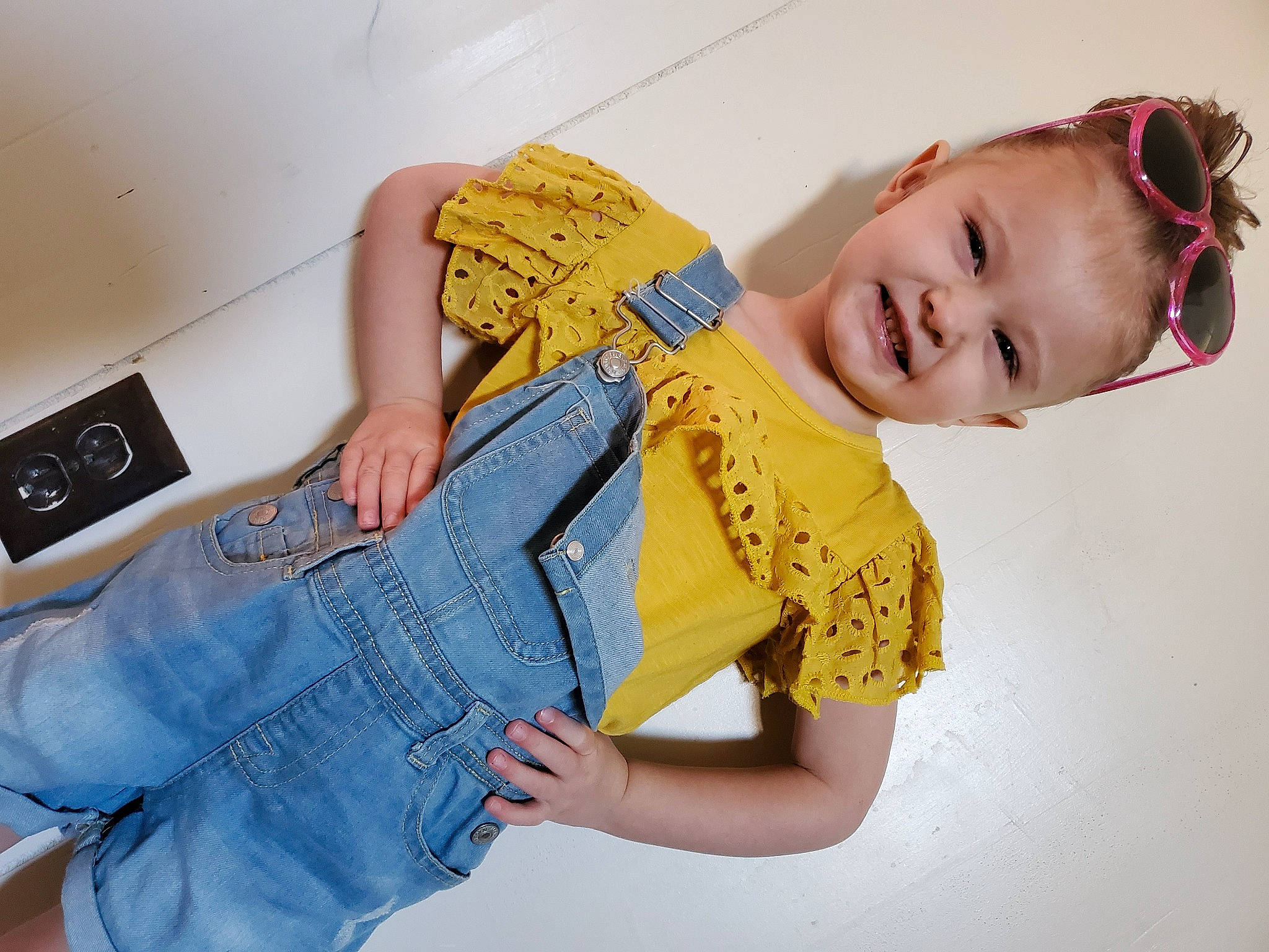Aleah is registered to the contest to win money with this photo: abdomen, child, denim, jeans, joint, joy, neck, overall, person, product, shoulder, sleeve, textile, toddler, trunk, waist, yellow