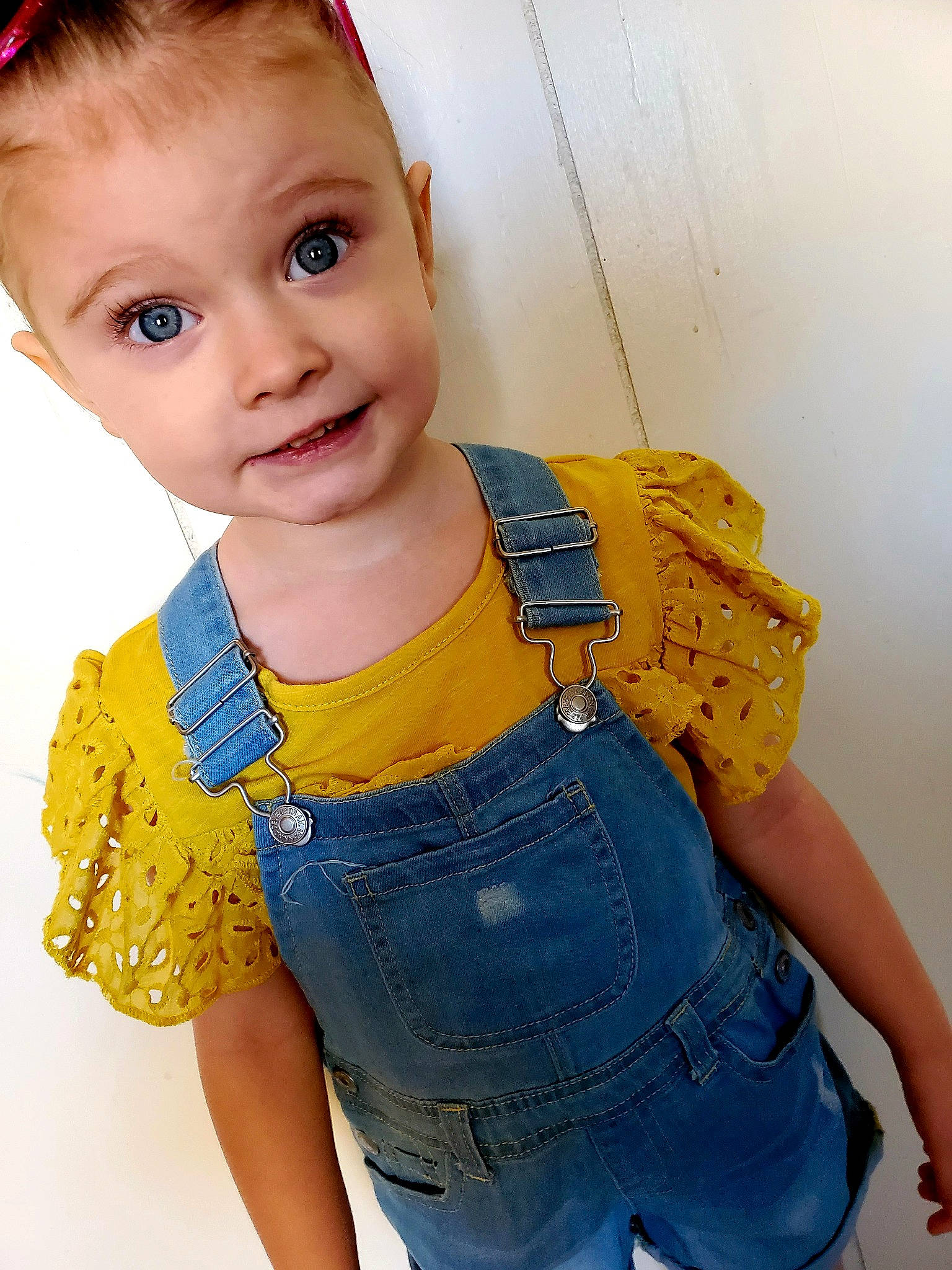 Aleah is registered to the contest to win money with this photo: abdomen, blue, child, child_model, clothing, denim, jeans, one_piece_garment, outerwear, overall, person, shorts, sleeve, smile, standing, textile, toddler, trousers, trunk, waist