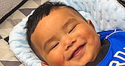 Liam is registered to the contest to win money with this photo: baby, smile, stroller, blue_outfit, cushion, happy, infant, child, face, portrait, comfort, hand, bracelet, indoor, baby_accessory, seat, closeup, head, cute, resting