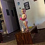 Baeleigh is registered to the contest to win money with this photo: toddler, child, diaper, coffee_table, sippy_cup, baby_bottle, carpet, living_room, wall_art, family_photos, furniture, indoor, person, foot, toy, curiosity, home, wall_socket, light_switch, wood