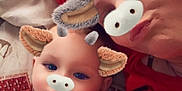 Baeleigh joined the competition — help win amazing prizes! baby, adult, face_filter, animal_ears, animal_nose, lying_down, bed, pillow, red_clothing, skin, portrait, closeup, playful, cute, family, child, smile, relaxed, indoor, person
