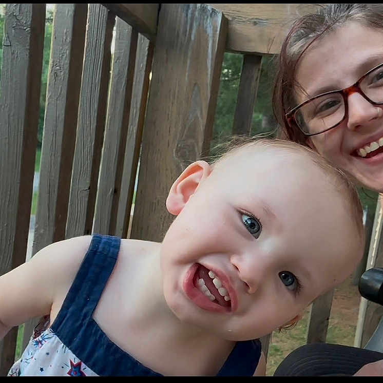 Baeleigh joined the competition — help win amazing prizes! balcony, casual, child, closeup, daylight, face, family, glasses, greenery, happy, nature, outdoor, person, playful, portrait, smiling, summer_clothing, toddler, woman, wooden_railings