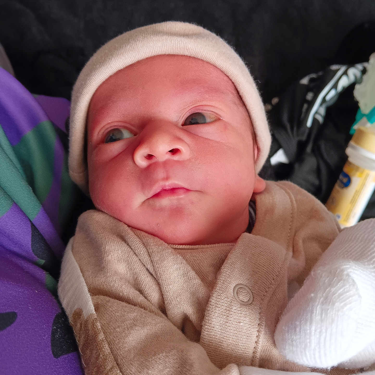 Jerrell joined the competition — help win amazing prizes! baby, beanie, blanket, bonnet, cap, clothing, face, glove, hat, head, hood, hoodie, knitwear, newborn, person, photography, portrait, sleeping, sweater, towel