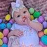 baby, infant, girl, bow, headband, tutu, dress, blanket, easter_eggs, colorful, pastel_colors, cute, lying_down, thumb_sucking, portrait, soft_texture, holiday, celebration, child, indoors