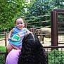 Eliott is registered to the contest to win money with this photo: baby, child, woman, elephant, zoo, outdoor, nature, greenery, fence, hair, smile, happy, animal, mammal, wildlife, holding, clothing, person, daylight, park