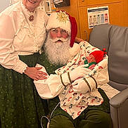 Jack joined the competition — help win amazing prizes! baby, newborn, santa_claus, mrs_claus, christmas, holiday, costume, beard, glasses, hat, blanket, red_hat, smile, woman, man, indoor, chair, cabinet, festive, gloves