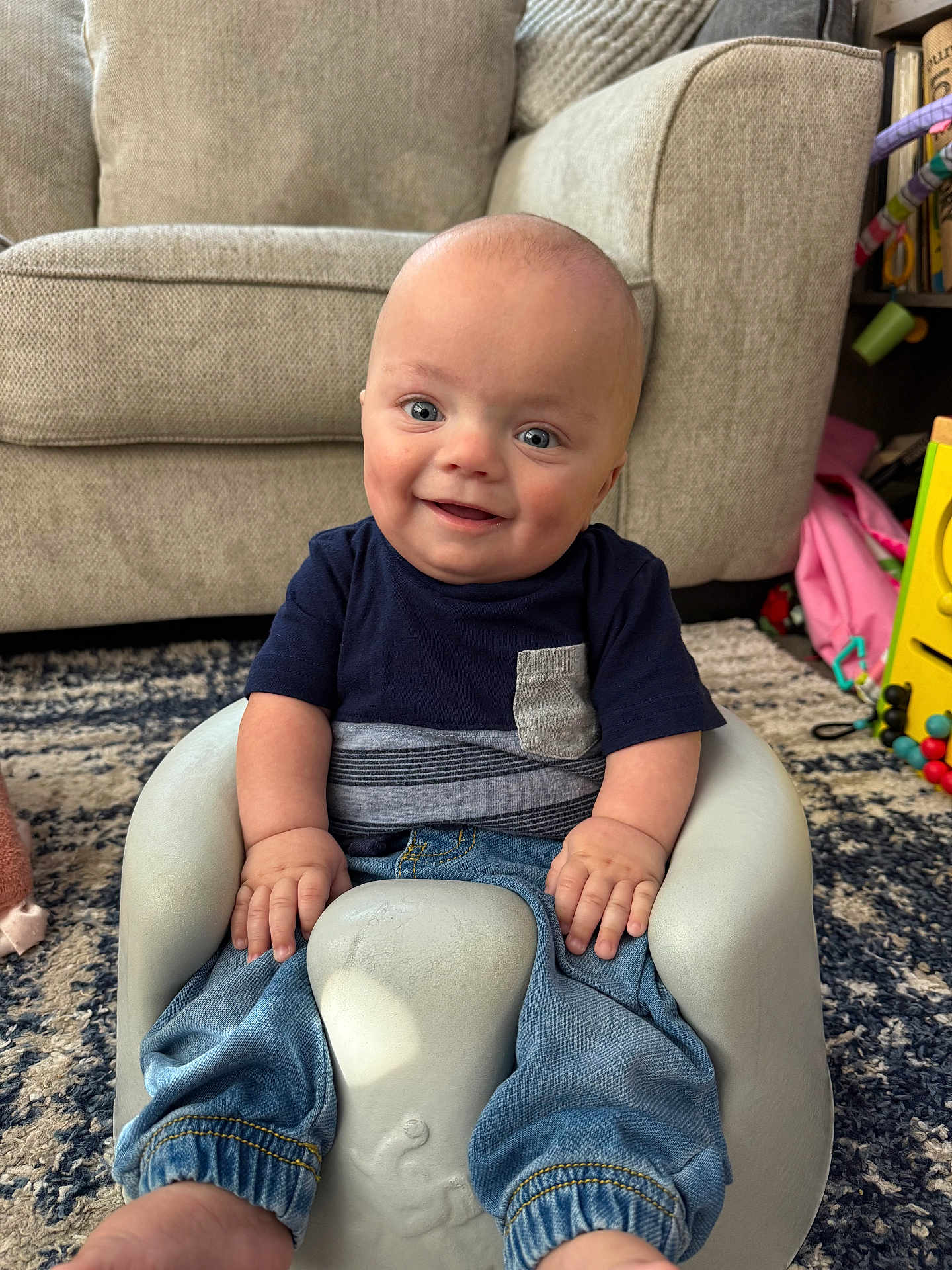 Jack joined the competition — help win amazing prizes! baby, infant, smile, blue_jeans, tshirt, baby_seat, living_room, carpet, couch, furniture, happy, child, hands, feet, cute, portrait, indoor, home, comfort, playroom