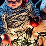 Joani is registered to the contest to win money with this photo: baby, child, infant, face, hand, christmas_lights, ornament, red_ornament, gold_ornament, teddy_bear, milestone_sign, clothing, floral_pattern, indoor, holiday, decorations, soft_light, closeup, cute, curious