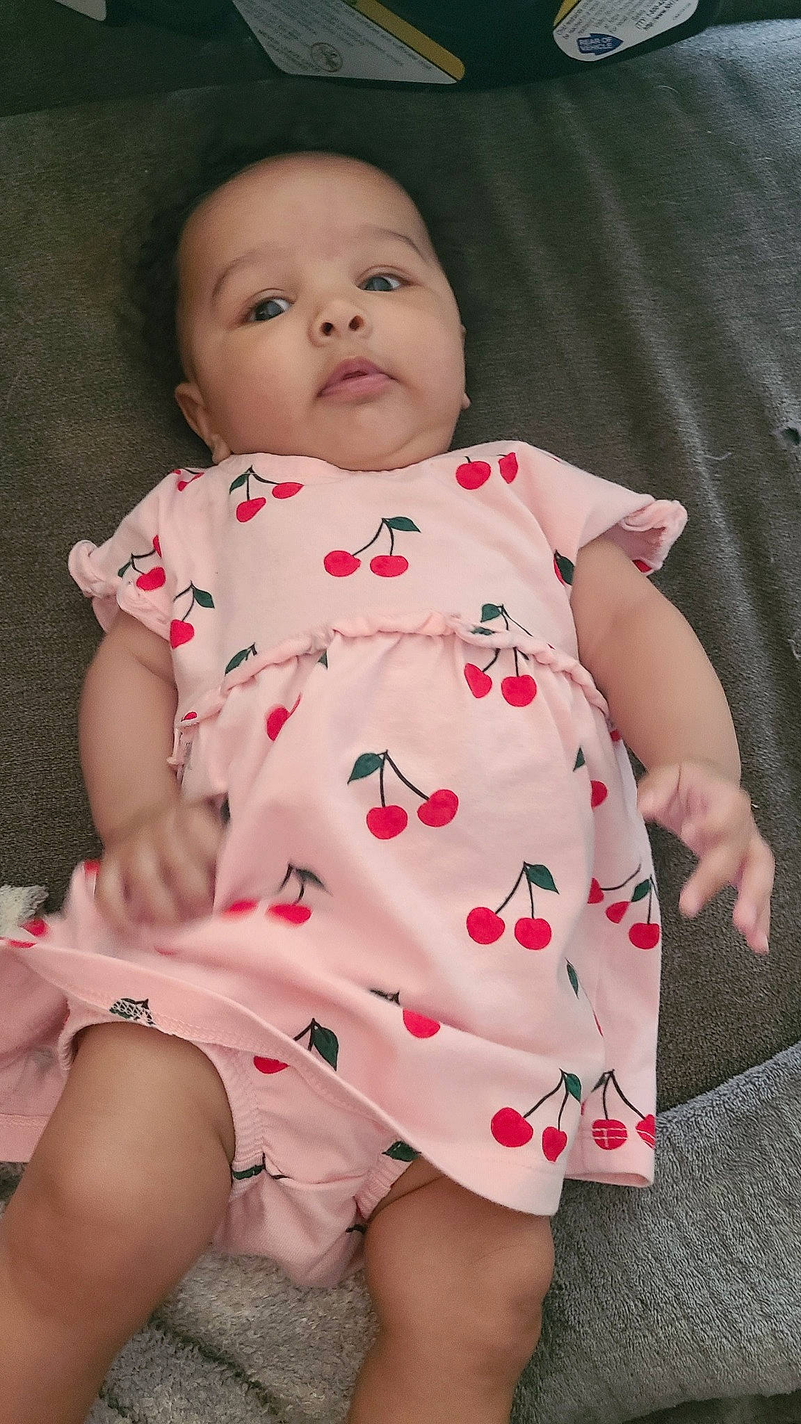 Leilani is registered to the contest to win money with this photo: baby, baby_toddler_clothing, cheek, child, collar, comfort, eye, finger, human_leg, iris, joint, lip, neck, one_piece_garment, pattern, person, pink, skin, sleeve, standing