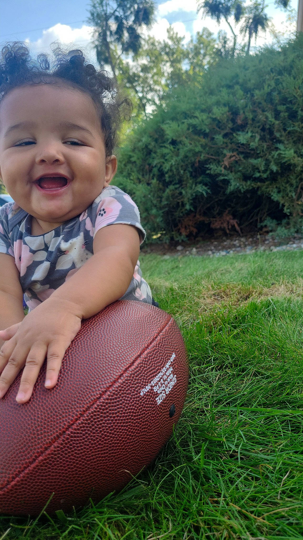 Leilani joined the competition — help win amazing prizes! automotive_tire, baby, baby_laughing, baby_toddler_clothing, ball, child, fun, grass, grassland, happy, joy, leisure, people_in_nature, person, plant, recreation, sitting, smile, sports_equipment, tire