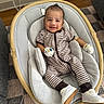 baby, smiling, onesie, mittens, baby_rocker, cushion, wooden_frame, footwear, indoor, carpet, floor, happy, infant, child, person, head, face, seated, cute, home