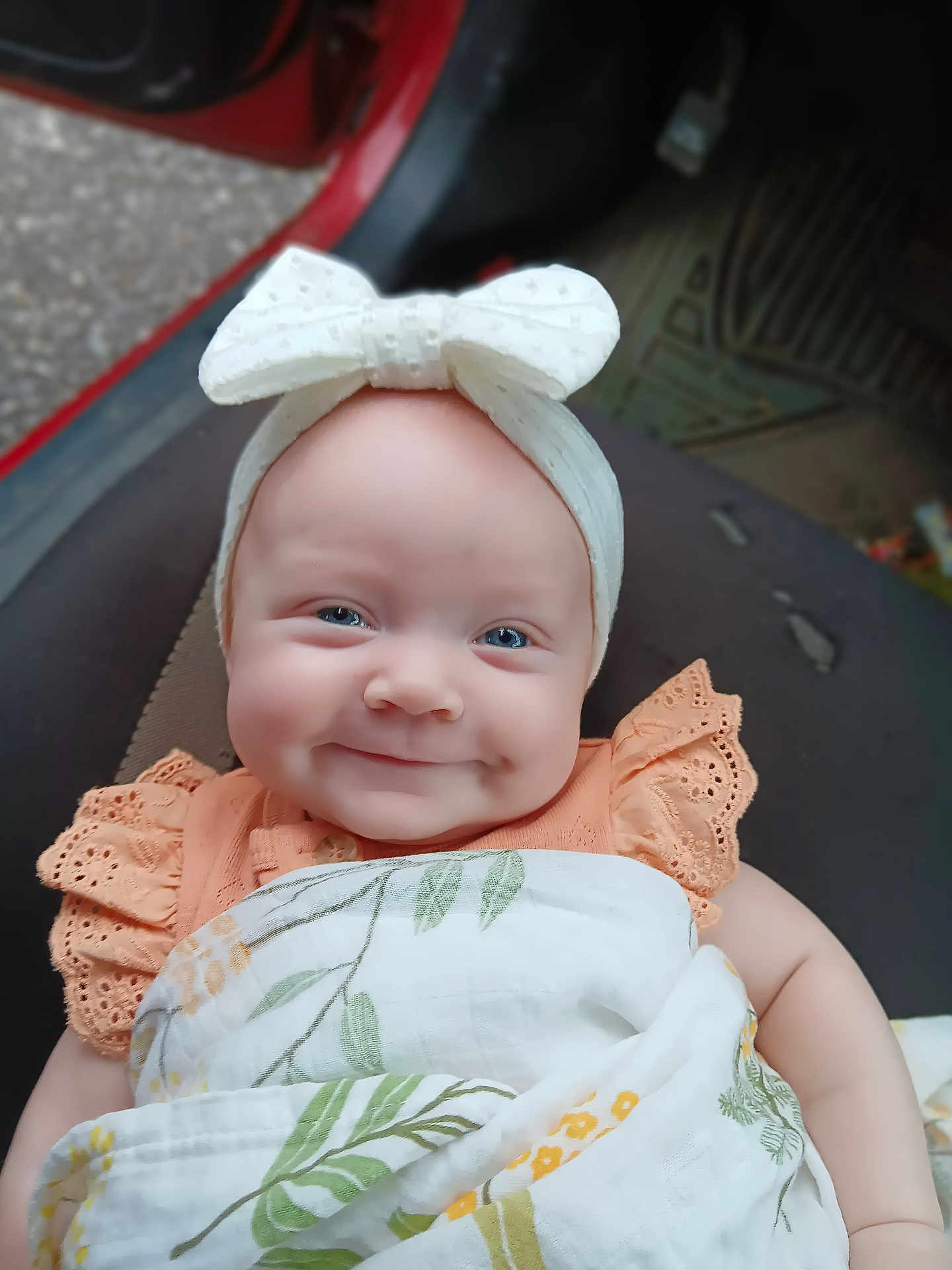 Priscilla joined the competition — help win amazing prizes! baby, smiling, headband, bow, blanket, orange_dress, blue_eyes, infant, cute, portrait, child, indoor, seat, fabric, pattern, happy, person, closeup, soft_light, clothing