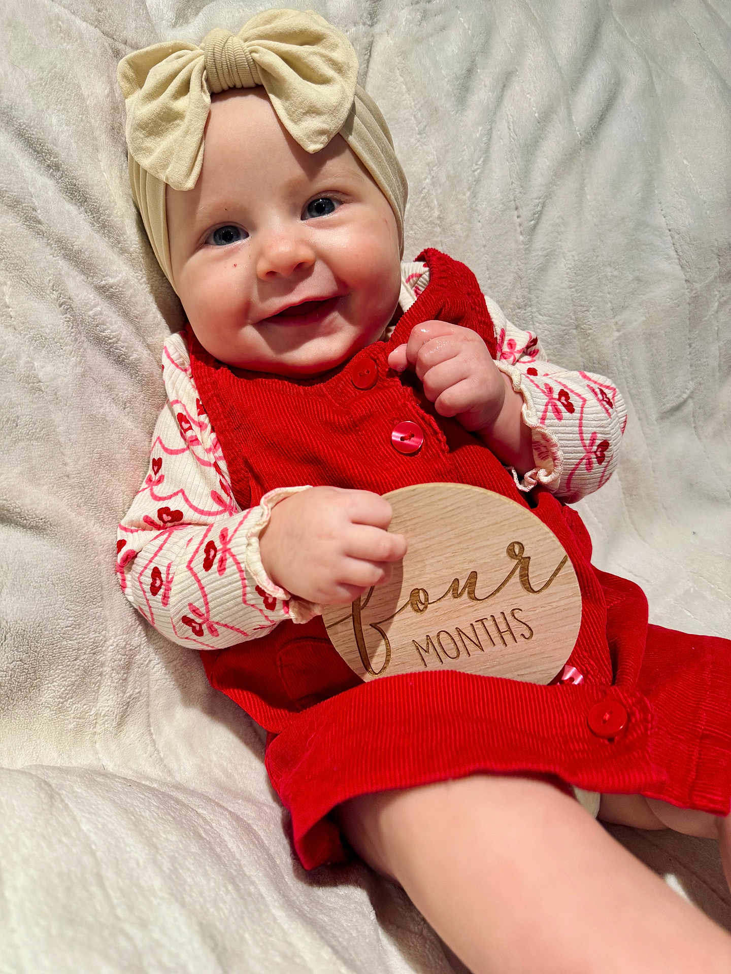 Sutton joined the competition — help win amazing prizes! baby, infant, smile, headband, bow, red_dress, wooden_sign, four_months, blanket, cute, child, portrait, happy, soft_texture, clothing, hand, face, eyes, skin, young