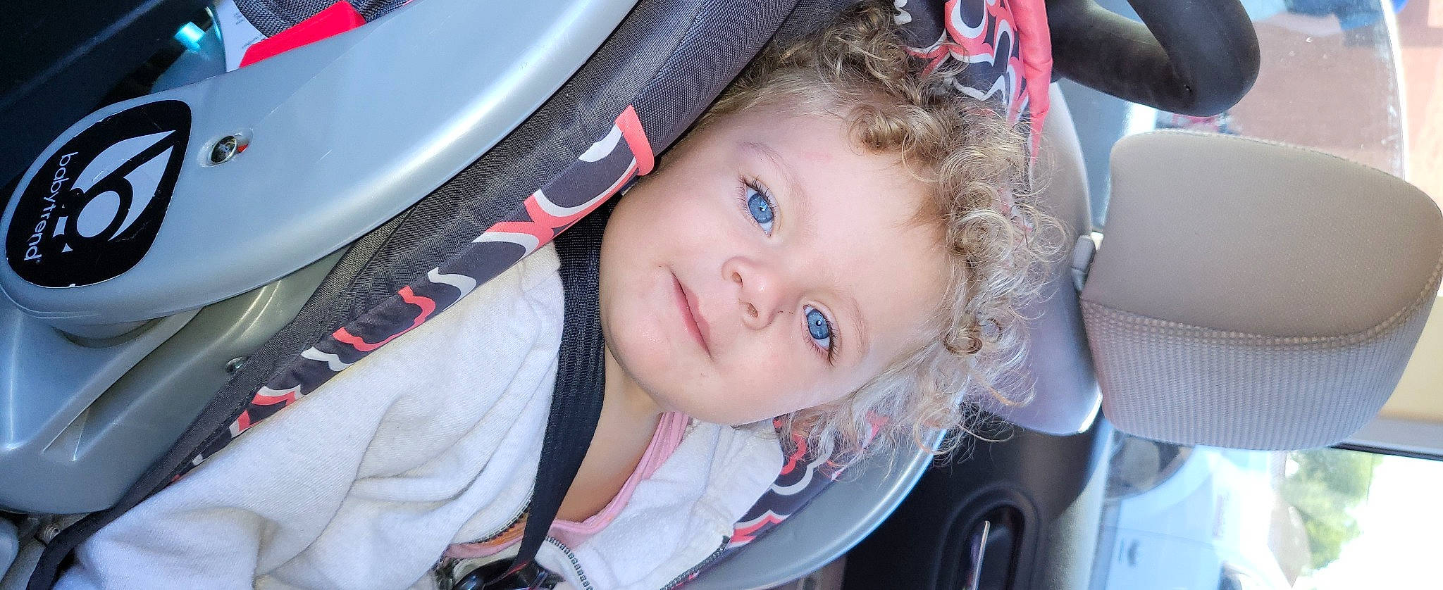 Jordyn is registered to the contest to win money with this photo: auto_part, automotive_design, baby, baby_carriage, baby_products, beauty, car_seat, carmine, cheek, electric_blue, fashion_accessory, fun, happy, lip, luxury_vehicle, motor_vehicle, person, personal_protective_equipment, smile, toddler