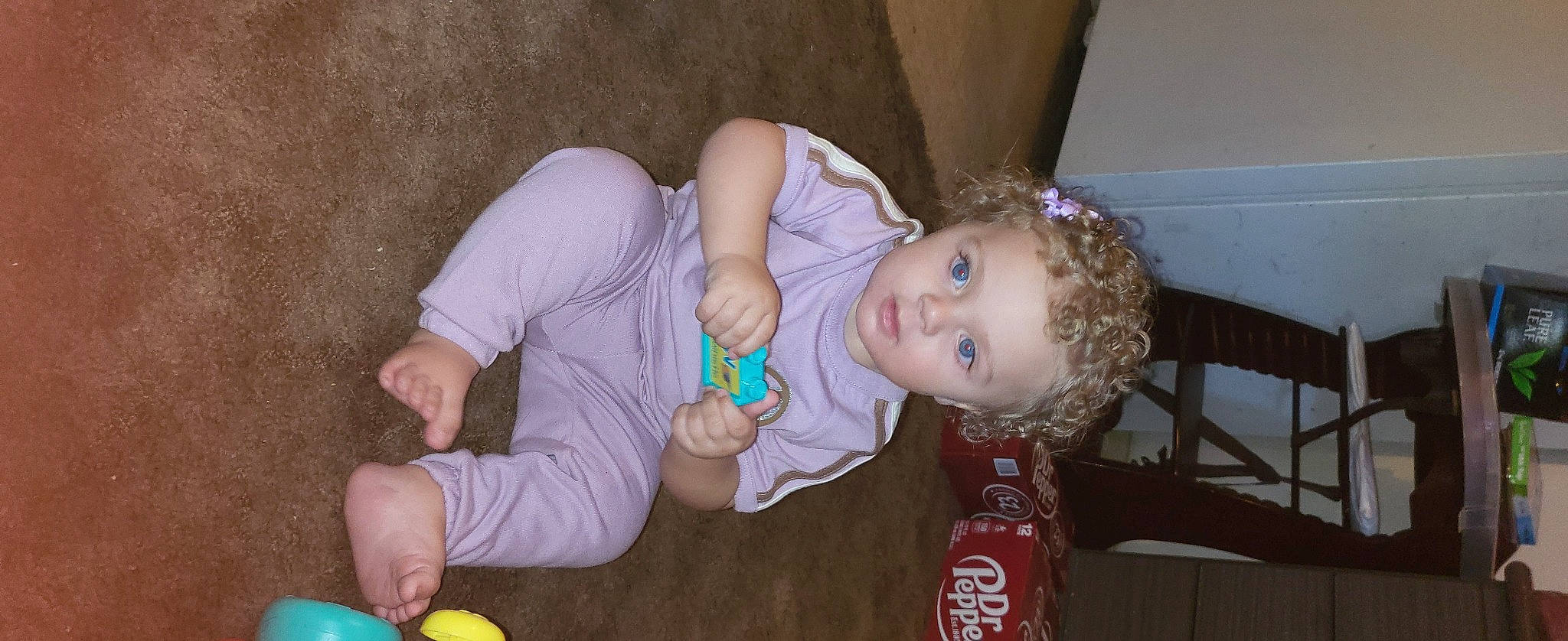 Jordyn is registered to the contest to win money with this photo: baby, baby_products, baby_toddler_clothing, carbonated_soft_drinks, cheek, child, event, face, fun, green, mouth, nail, nose, person, play, sitting, skin, sports_toy, toddler, toy