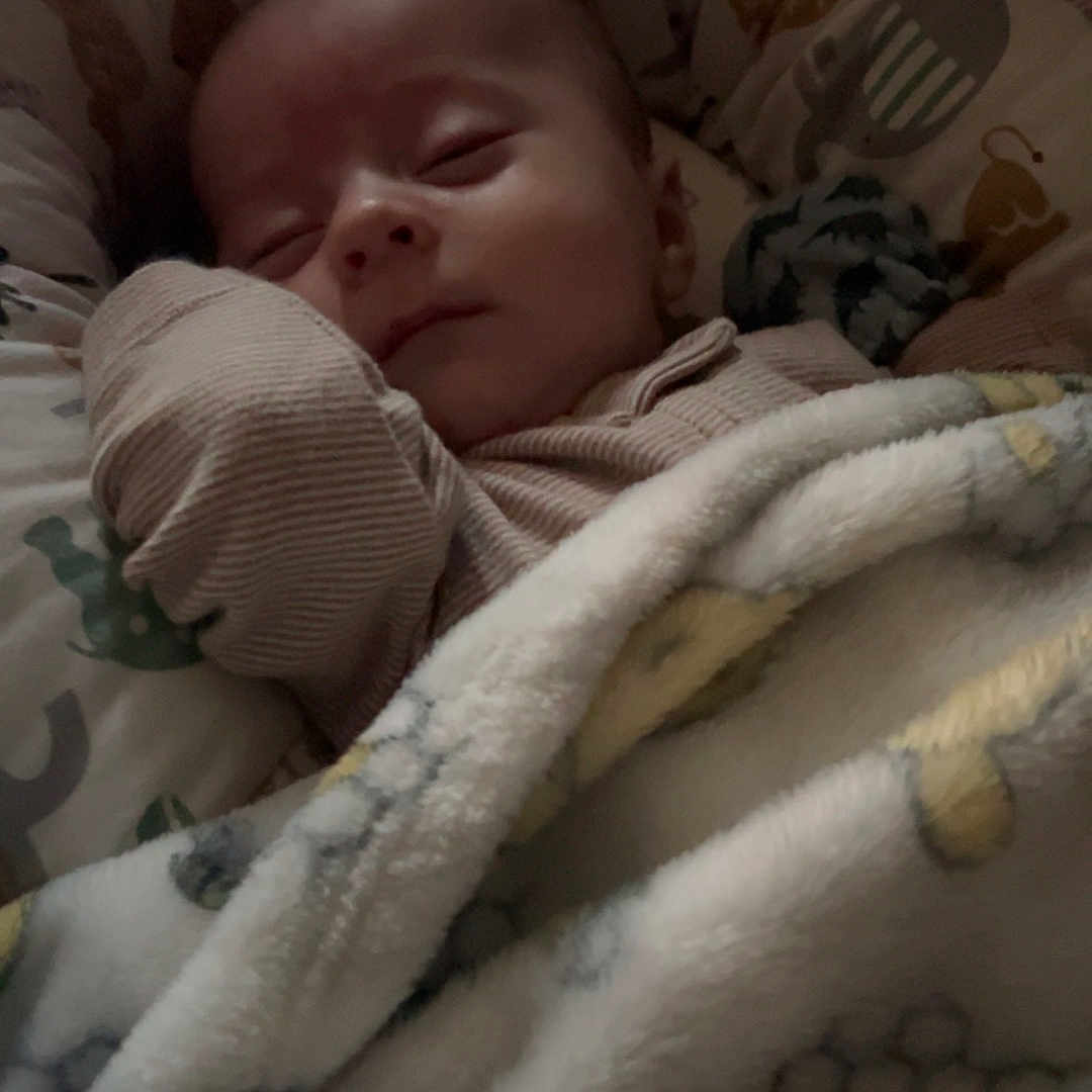 Jeremiah is registered to the contest to win money with this photo: baby, bed, bedroom, blanket, cradle, crib, cushion, face, furniture, head, indoors, infantbed, newborn, person, photography, portrait, quilt, room, sleeping, towel