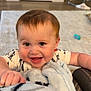 baby, child, smiling, blanket, indoor, happy, face, cute, infant, toddler, clothing, hand, home, carpet, toy, furniture, person, expression, warm, cozy