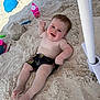 baby, sand, beach, child, sandy, smiling, toys, umbrella, shorts, play, summer, outdoor, happy, feet, legs, face, hand, relaxing, fun, vacation