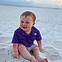 baby, child, smiling, purple_shirt, sand, beach, sitting, barefoot, sunset, outdoor, cute, happy, infant, playful, nature, young_child, portrait, casual_clothing, summer, relaxing