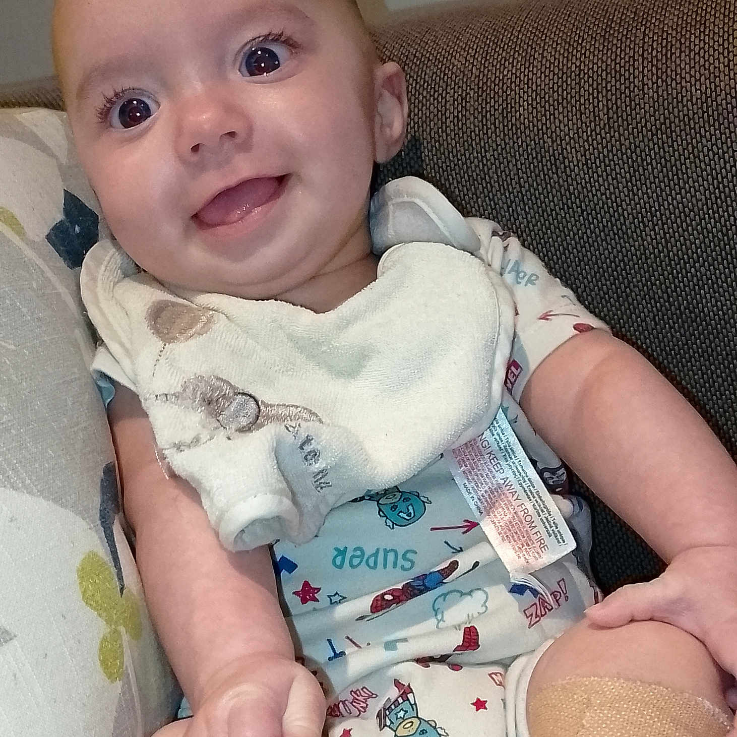 Reuben is registered to the contest to win money with this photo: arm, baby, bandage, bodypart, chair, clothing, couch, cushion, face, finger, firstaid, furniture, hand, head, homedecor, hosiery, person, photography, portrait, sock