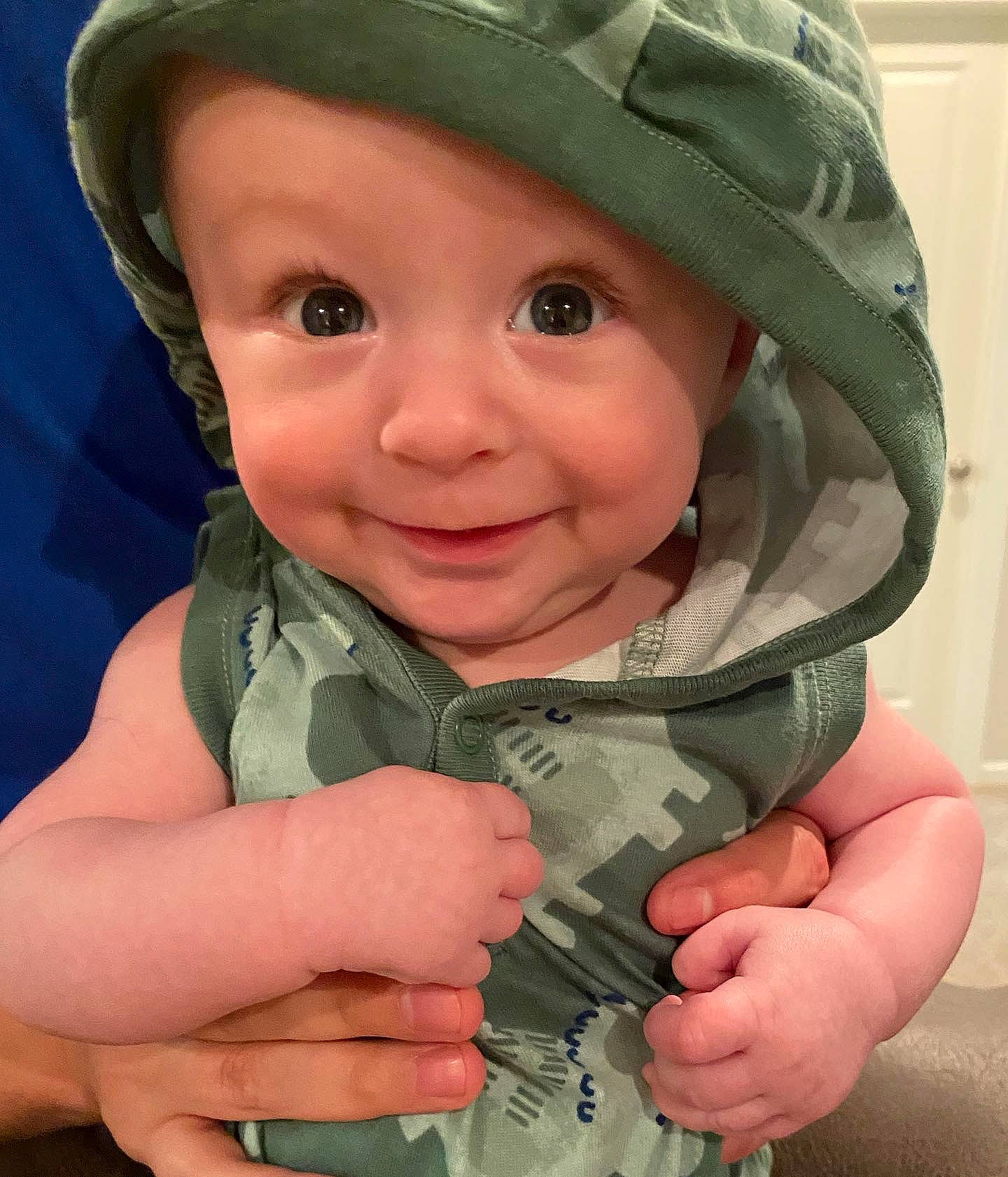 Aidan is registered to the contest to win money with this photo: camouflage, cap, cheek, chin, eye, eyebrow, face, facial_expression, forehead, gesture, hand, head, headwear, lip, military_camouflage, nose, outerwear, person, photograph, skin