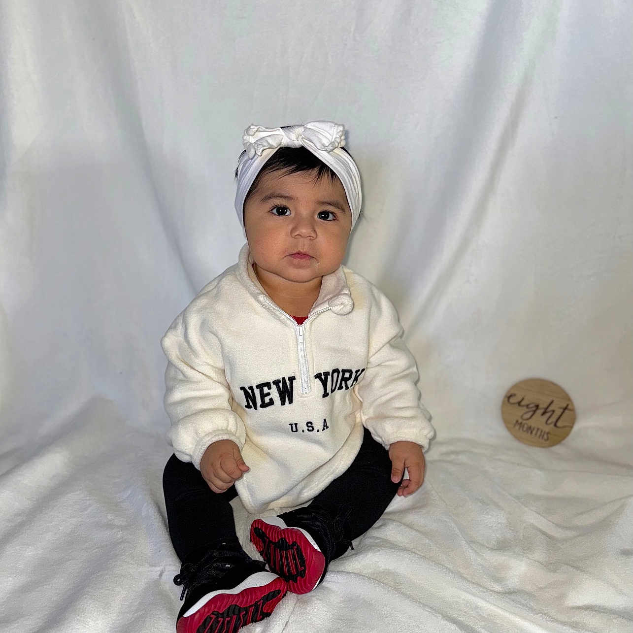 Janellie is registered to the contest to win money with this photo: bonnet, boy, cap, child, clothing, face, footwear, glove, hat, head, knitwear, male, pants, person, photography, portrait, shoe, sitting, sneaker, sweater