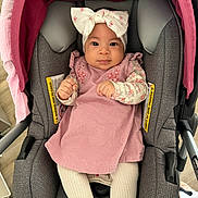 Jaylani joined the competition — help win amazing prizes! baby, baby_girl, bow, car_seat, child, clothing, cute, fabric, floor, hands, headband, indoor, infant, looking_at_camera, person, pink_dress, portrait, seat, soft, tights