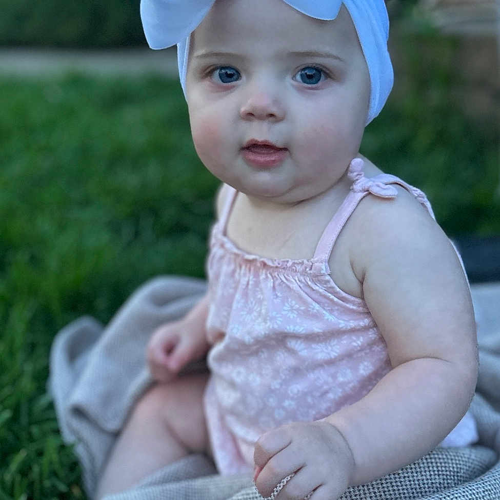 Emily joined the competition — help win amazing prizes! accessories, baby, bonnet, cap, clothing, costume, dress, face, formalwear, grass, hat, head, homedecor, lawn, linen, pants, person, photography, plant, portrait