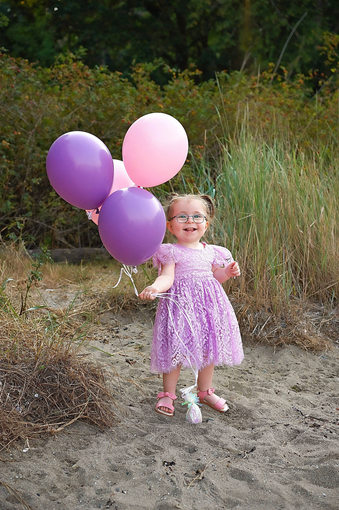 Madalyn is registered to the contest to win money with this photo: baby_toddler_clothing, balloon, child, fun, gesture, grass, grassland, happy, joy, leisure, magenta, natural_environment, party_supply, people_in_nature, person, pink, plant, prairie, recreation, smile