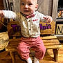 Bella is registered to the contest to win money with this photo: baby, bench, bow_tie, child, cute, face, floor, furniture, happy, home, indoor, motion_blur, person, pink_pants, playful, shirt, smiling, socks, wood_floor, wooden_bench
