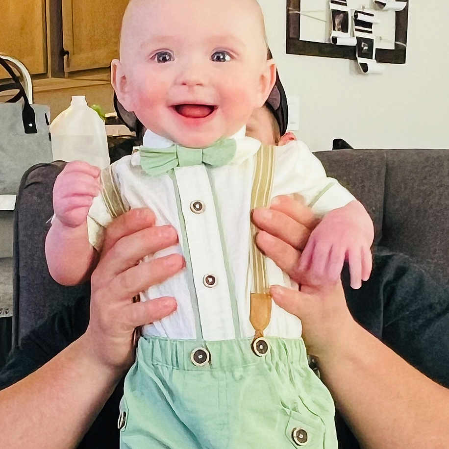 Cruz joined the competition — help win amazing prizes! accessories, baby, bag, bodypart, clothing, coat, couch, cutlery, face, finger, furniture, hand, head, jacket, pants, person, photography, portrait, shorts, spoon