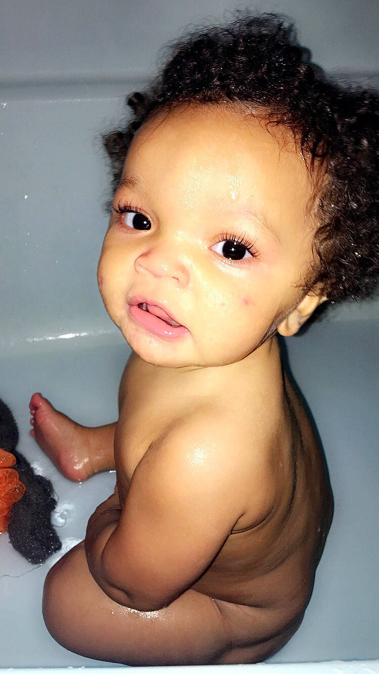 Giovani is registered to the contest to win money with this photo: baby, bathing, black_hair, cheek, child, child_model, chin, eye, eyebrow, face, forehead, hair, hairstyle, head, lip, neck, nose, person, skin, smile