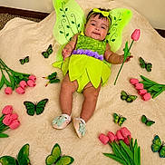 Abbie Grace joined the competition — help win amazing prizes! baby, infant, fairy_costume, green_wings, pink_tulip, flowers, butterflies, blanket, headband, smiling, cute, child, indoors, soft_texture, playful, costume, shoes, green, pink, decorative