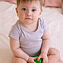 baby, child, infant, sitting, toys, balls, bed, pillow, blanket, indoors, cute, soft, clothing, person, hands, feet, skin, face, expression, young