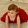 baby, child, red_dress, crawling, blue_eyes, blanket, indoors, golden_balloons, curious, soft_lighting, hands, face, hair, cute, portrait, infant, floor, celebration, young, skin