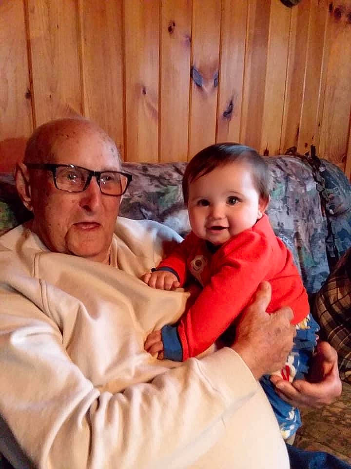 Malakai is registered to the contest to win money with this photo: baby, child, comfort, couch, event, eyewear, fun, glasses, happy, holiday, lap, living_room, person, room, sitting, smile, thumb, toddler, vacation, vision_care