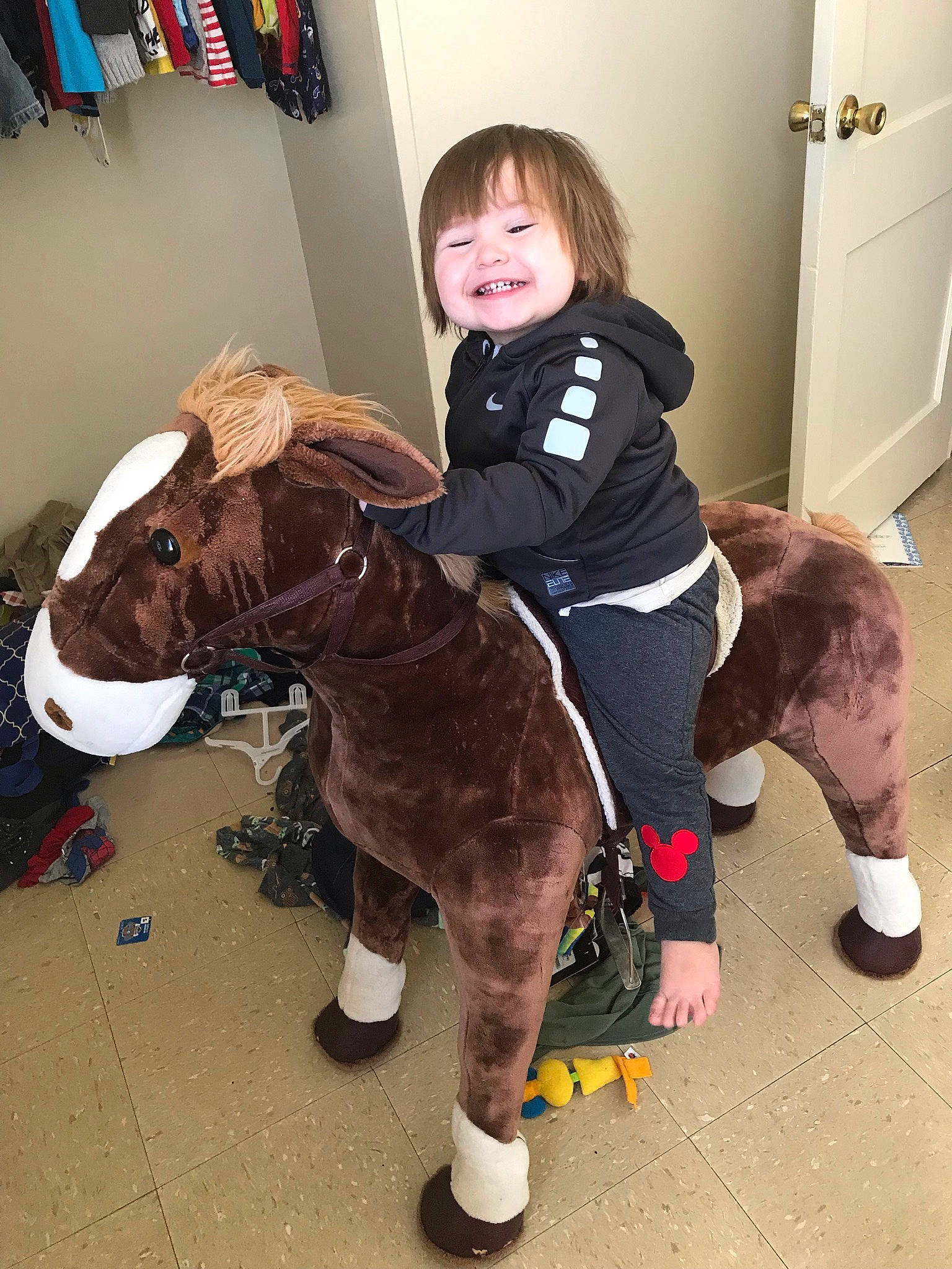 Malakai is registered to the contest to win money with this photo: bag, boot, chair, child, event, fawn, fictional_character, flooring, fun, fur, head, joy, knee, luggage_and_bags, person, personal_protective_equipment, shoe, smile, sneakers, toddler