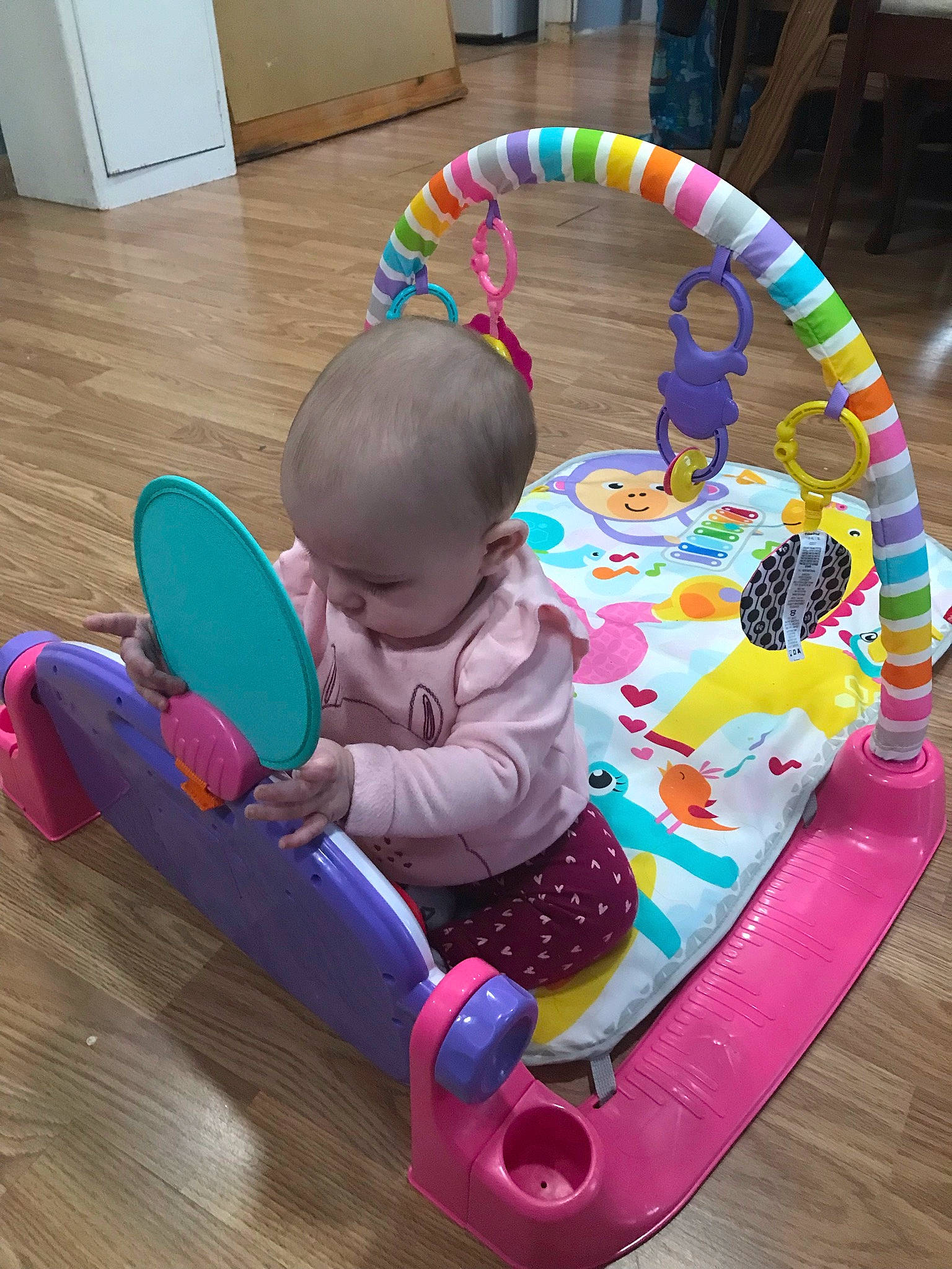 Khalani is registered to the contest to win money with this photo: baby, baby_playing_with_toys, baby_products, baby_toddler_clothing, baby_toys, cabinetry, child, circle, comfort, flooring, fun, hardwood, leisure, person, play, recreation, sharing, sitting, toddler, toy