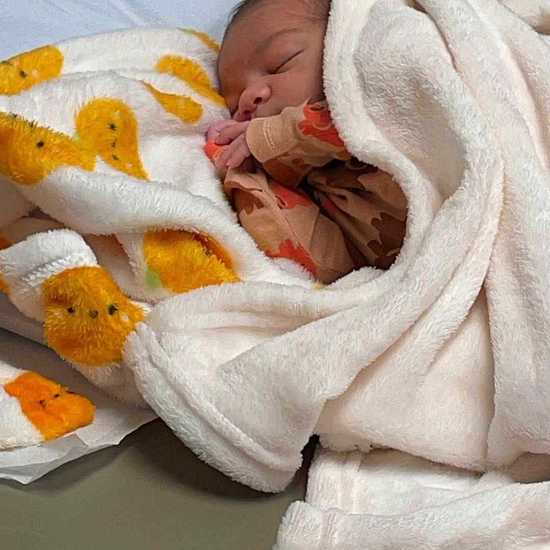 Brooklynn is registered to the contest to win money with this photo: architecture, baby, bed, bedroom, blanket, building, cushion, face, furniture, head, hospital, indoors, newborn, person, photography, portrait, quilt, room, sleeping, towel