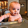 Oliver joined the competition — help win amazing prizes! baby, high_chair, food, face, mouth, arm, hand, indoor, cabinet, light, furniture, child, skin, expression, curious, smudged_food, room, decor, sign, blessed