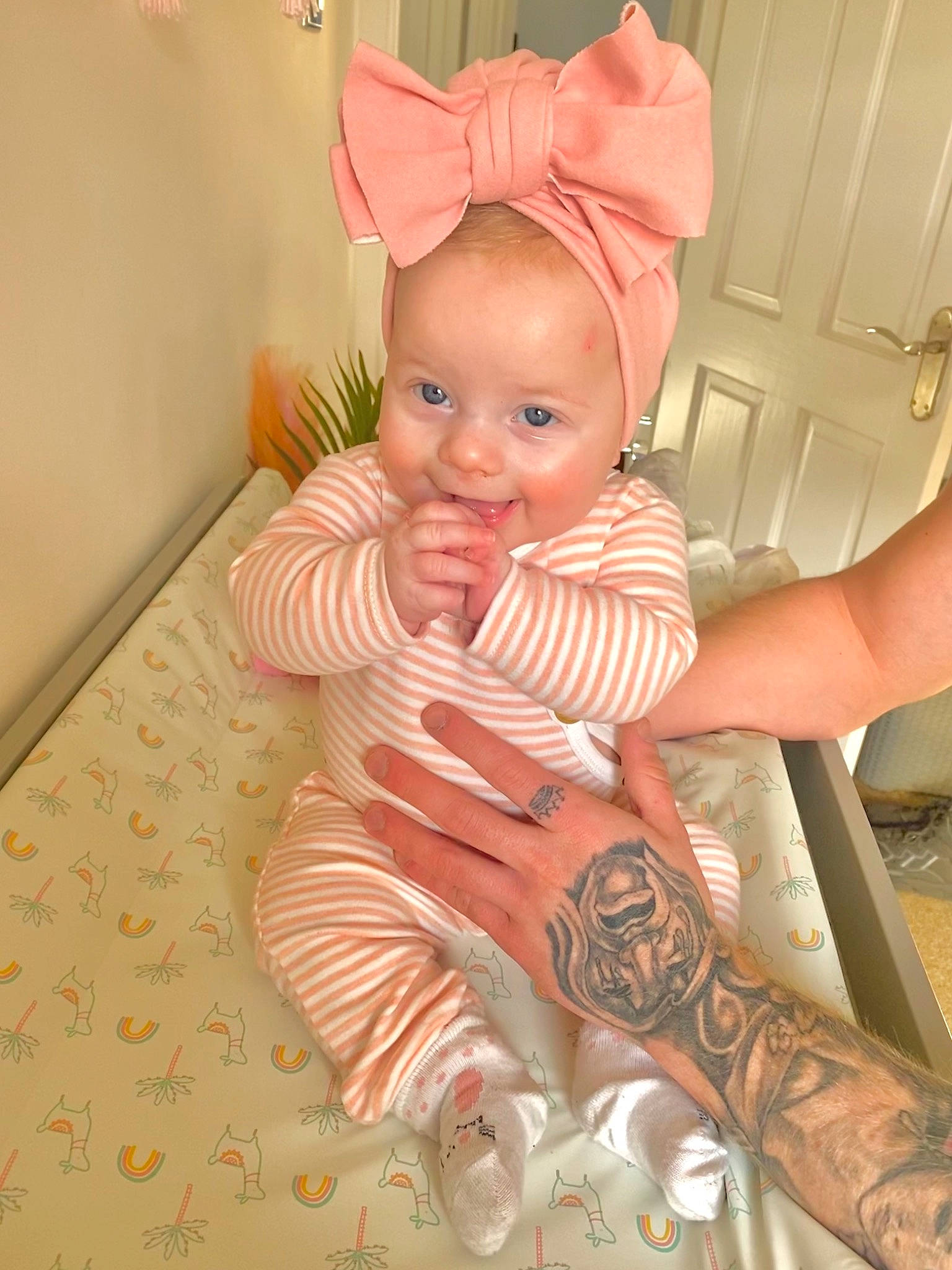 Lottie is registered to the contest to win money with this photo: baby, baby_toddler_clothing, cheek, comfort, eye, face, finger, flooring, happy, head, human_body, mouth, nose, person, pink, skin, sleeve, smile, thumb, toddler