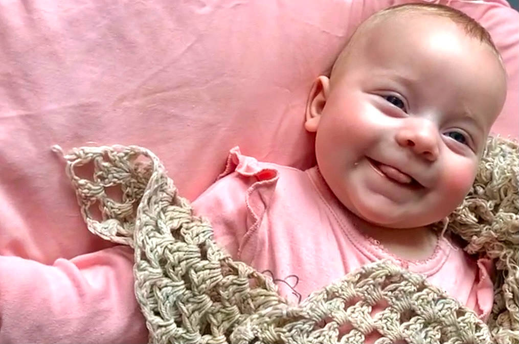 Lottie is registered to the contest to win money with this photo: baby, baby_toddler_clothing, cheek, chin, dress, eye, face, happy, head, human, iris, joy, lip, mouth, nose, outerwear, person, pink, skin, sleeve