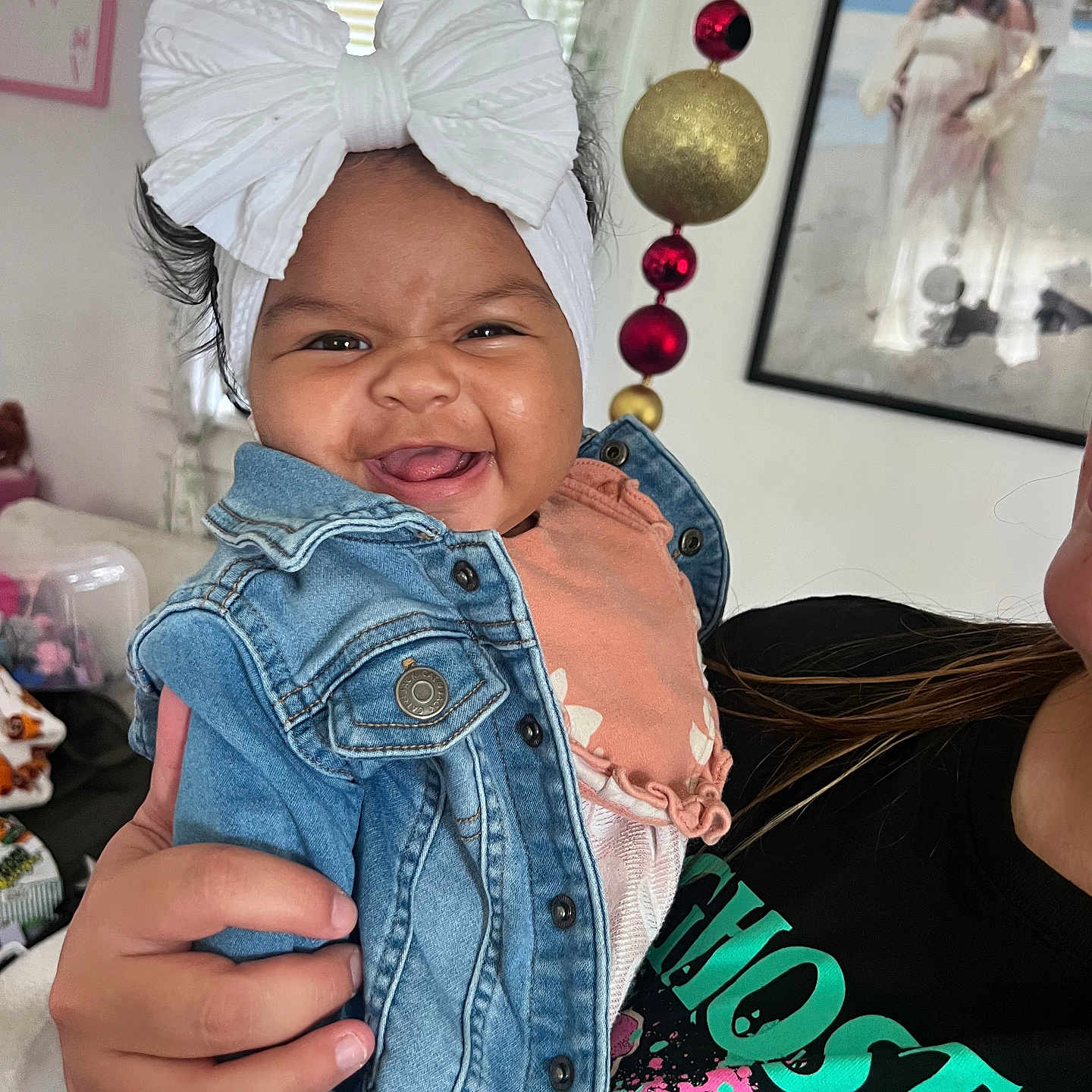 Feyre joined the competition — help win amazing prizes! baby, casual, child, clothing, cute, decorations, denim_jacket, face, family, framed_photo, hand, happy, headband, indoor, person_holding, portrait, room, smiling, toddler, white_bow