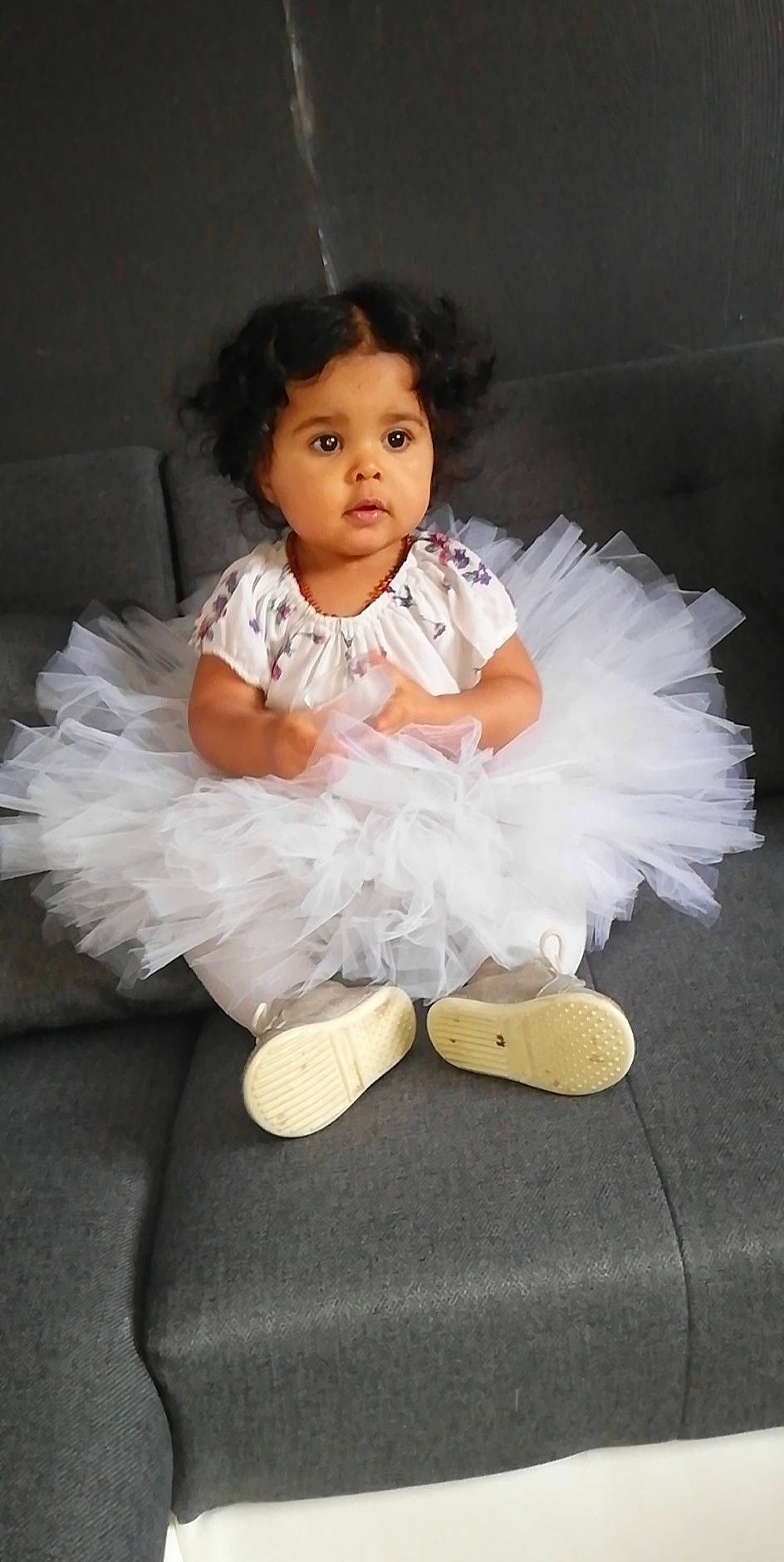 Maïly participe au concours pour gagner de l'argent avec cette photo : baby, baby_toddler_clothing, cheek, child, costume, day_dress, dress, embellishment, face, fashion_accessory, fashion_design, flash_photography, fun, happy, headpiece, person, ruffle, sitting, sleeve, sock