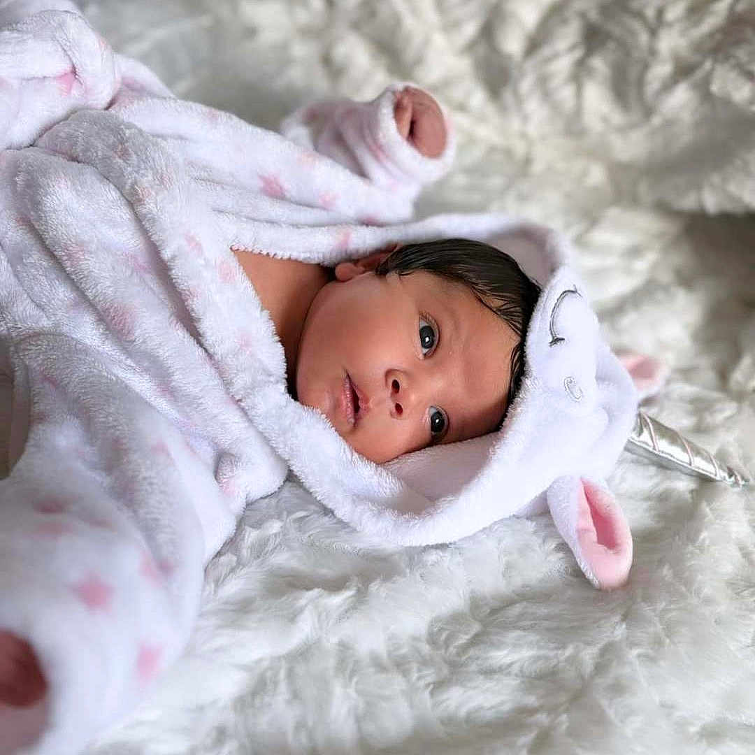Kailany joined the competition — help win amazing prizes! baby, blanket, bonnet, clothing, face, happy, hat, head, newborn, person, photography, portrait, quilt, smile, yawning