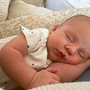 Mathéo participe au concours pour gagner de l'argent avec cette photo : baby, sleeping, infant, peaceful, pillow, pattern, white_clothing, dots, closeup, face, arm, hand, skin, indoors, cozy, soft, cute, newborn, resting, portrait