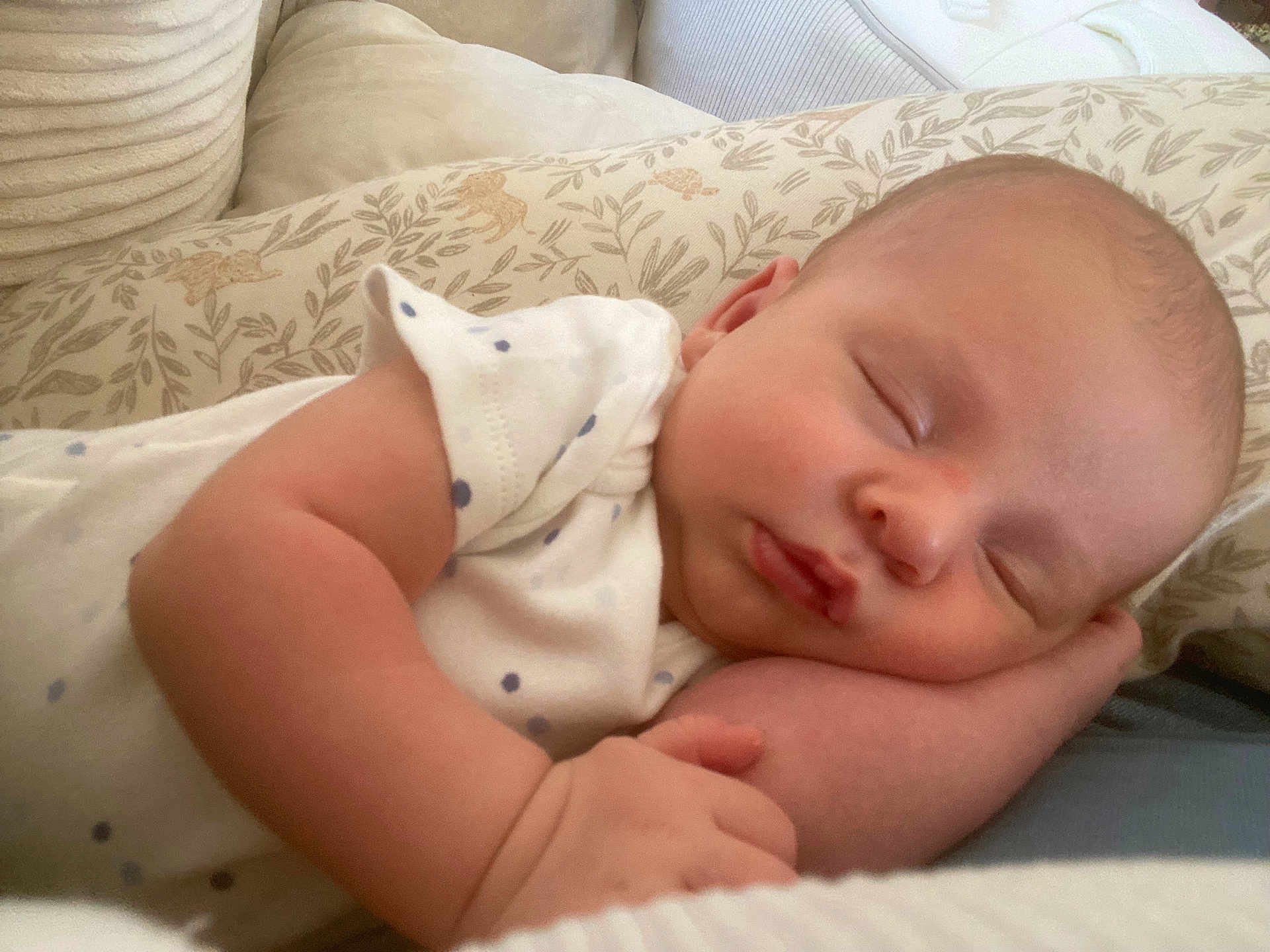Mathéo participe au concours pour gagner de l'argent avec cette photo : baby, sleeping, infant, peaceful, pillow, pattern, white_clothing, dots, closeup, face, arm, hand, skin, indoors, cozy, soft, cute, newborn, resting, portrait