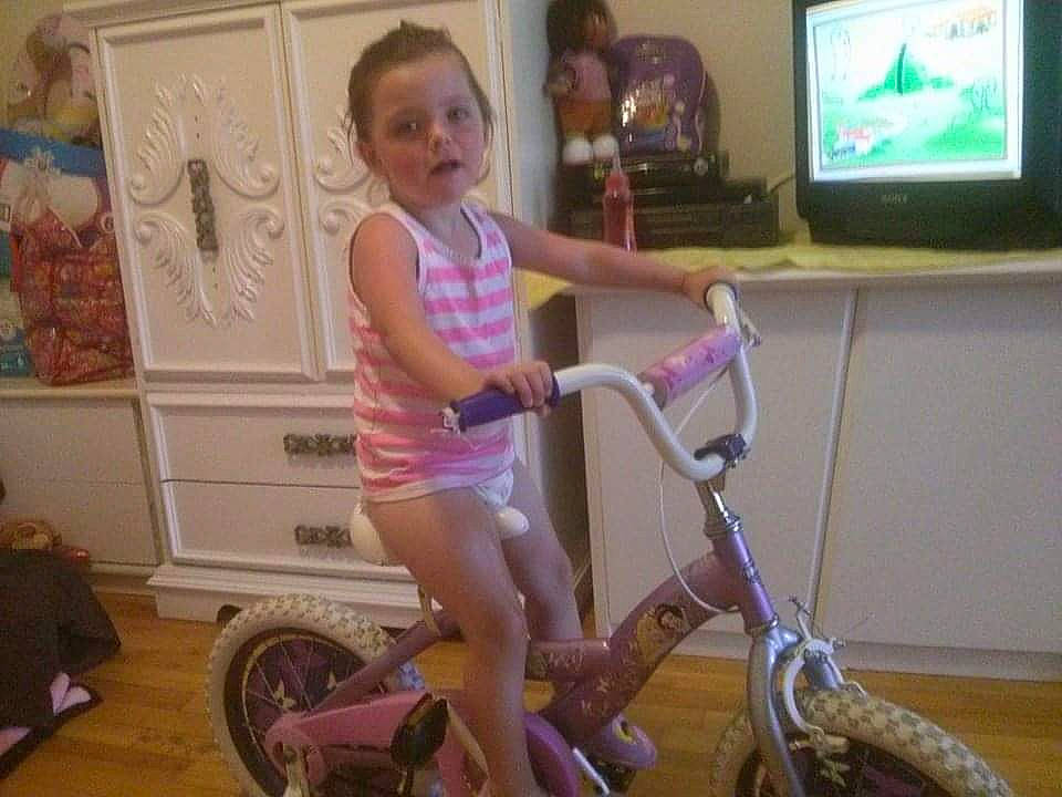 Kelly-ann a rejoint le concours — aidez-le/la à gagner de superbes lots ! bicycle, bicycle_accessory, bicycle_fork, bicycle_frame, bicycle_handlebar, bicycle_saddle, bicycle_tire, bicycle_wheel, fun, leisure, magenta, person, pink, riding_toy, spoke, television, television_set, tire, toddler, vehicle