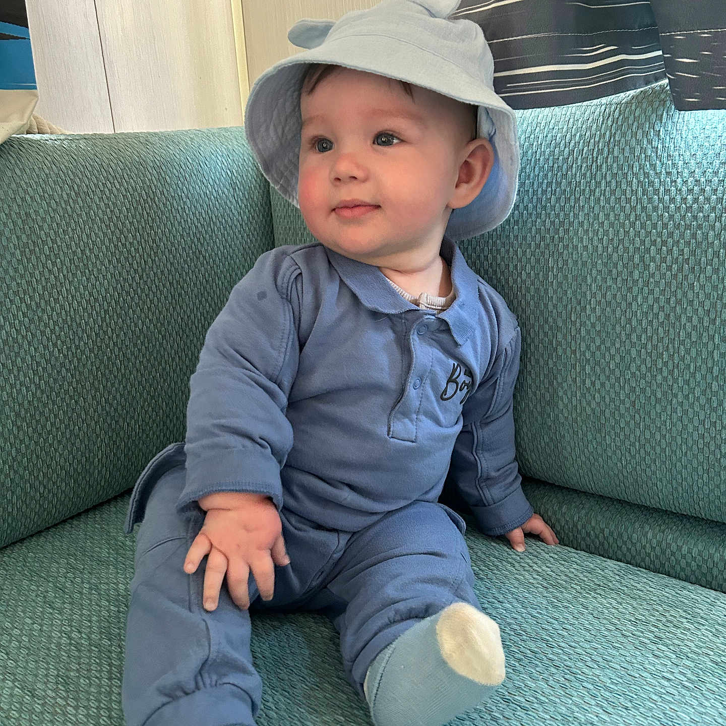 Levi is registered to the contest to win money with this photo: baby, baseballcap, cap, clothing, couch, cushion, face, furniture, hat, head, homedecor, hosiery, jeans, pants, person, photography, portrait, sitting, sleeve, sock